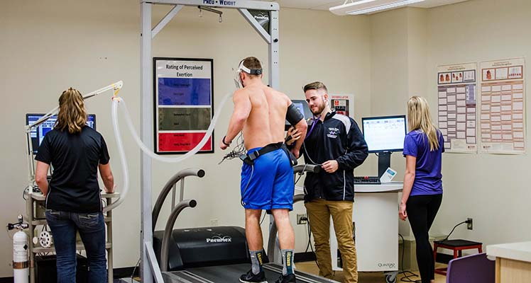 Students testing man on treadmill