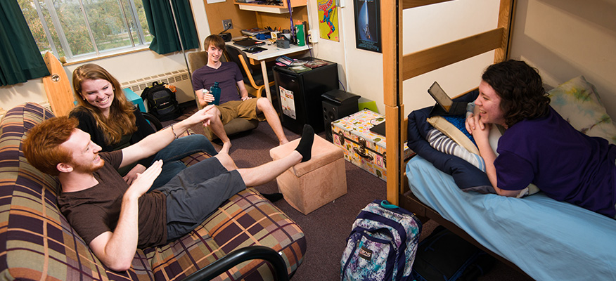 WSU students hang out together in a residence hall room.
