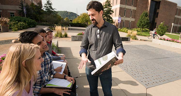 Professor talking to students outside