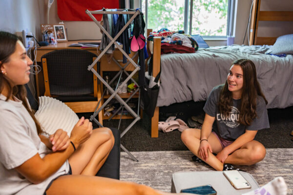 Two students chat in their WSU residence hall room.