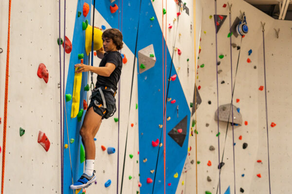 A student climbs to the top of the WSU Climbing Wall.