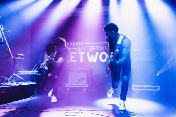 Two musicians perform on stage a concert on campus.