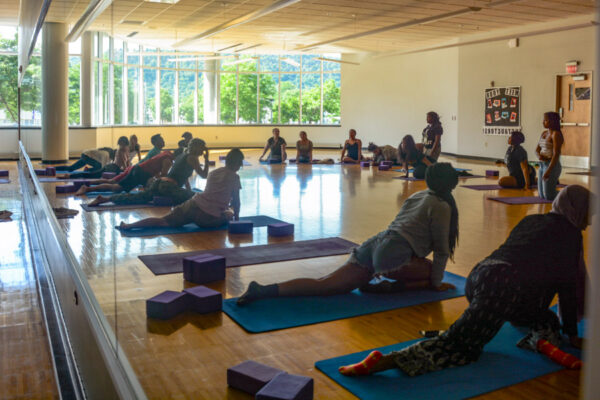 People do yoga during a group fitness class in the WSU Fitness Center.