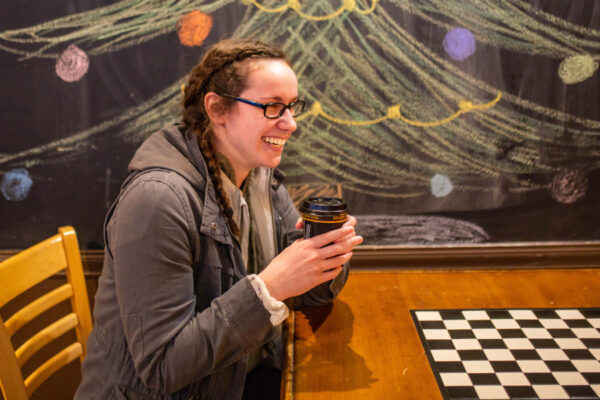 A student enjoys a coffee at a local coffee shop in Winona.