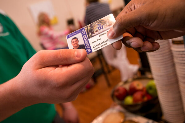 A student uses their Warrior ID card to make a purchase on campus.