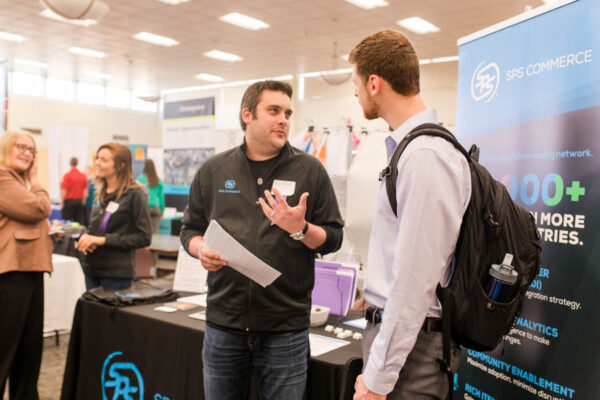 A male student talks to a job recruiter at a WSU Career Fair event.