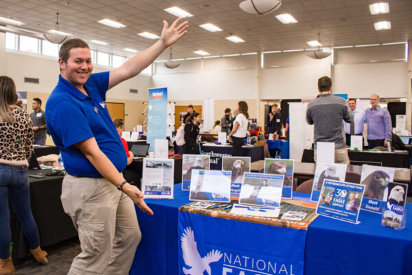 An employer shows off the booth at a WSU Career Fair.