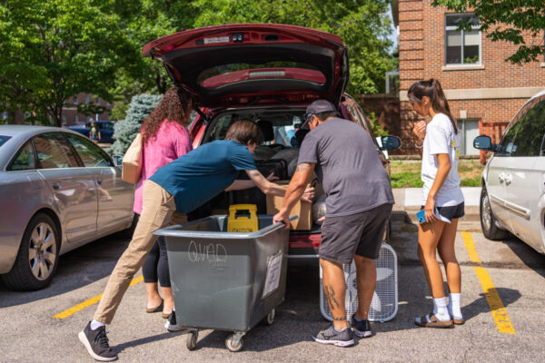 A family unloads items from a car to move their student into the WSU residence halls.