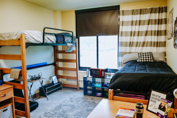 A bedroom with two beds in a residence hall on WSU campus.