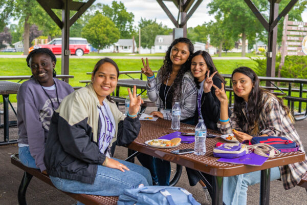 A group of international students hang out together in a park in Winona.