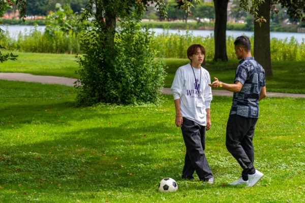 Two students casually play with a soccer ball at a park in Winona.