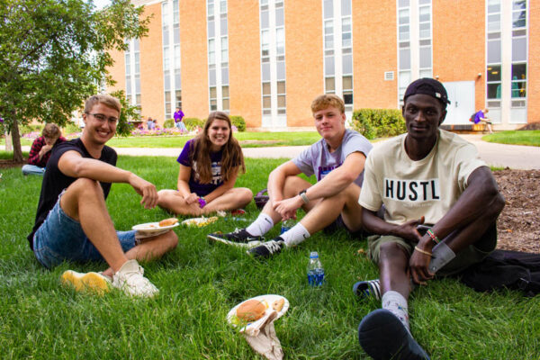 Students sit and eat lunch on the lawn during WSU's Welcome Week.
