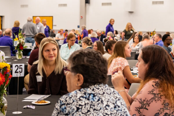 Students talk with donors at tables during the annual Scholarship Banquet on the WSU campus.