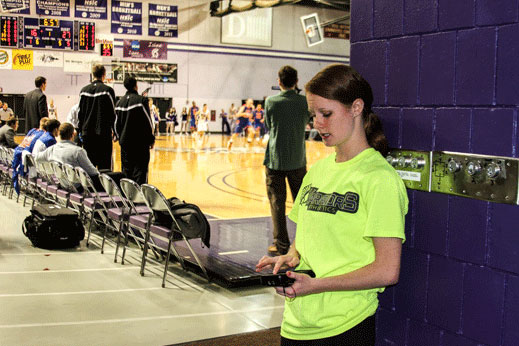 Student taking tickets at basketball game.