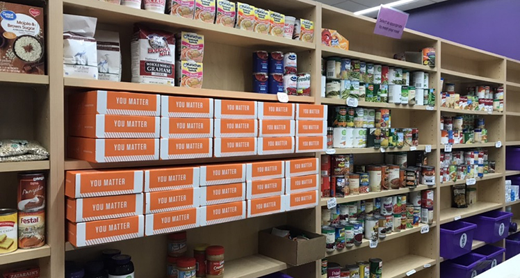 Shelves in the Warrior Cupboard are stocked with food and supplies for students. 