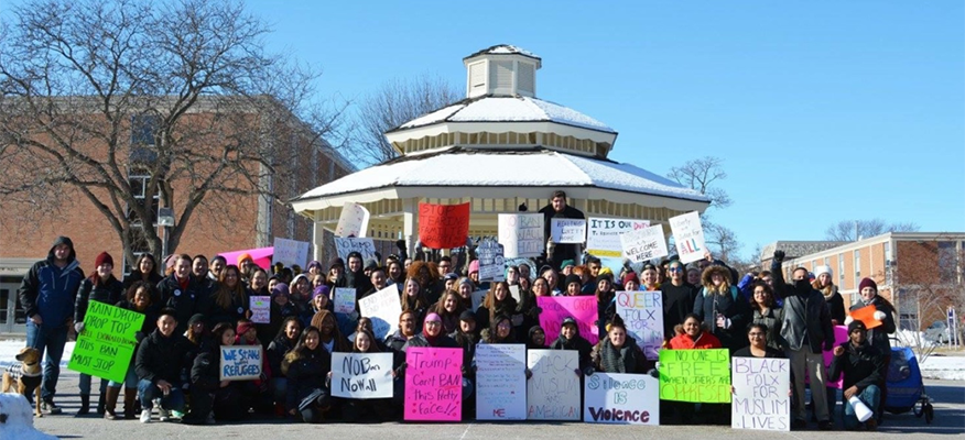 Student activists with signs in front of the gazebo.