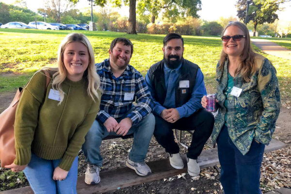 WSU alumni pose together at an outdoor event.