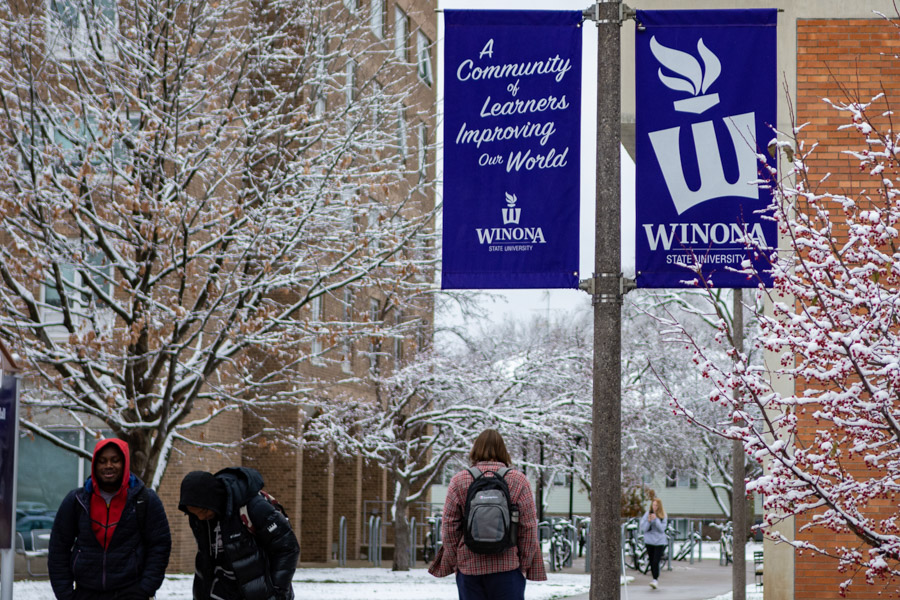 Students walk across the Winona campus in the winter.