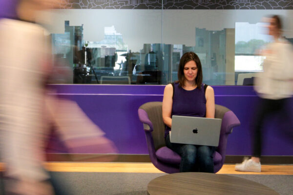 A student works on a laptop in a lounge on WSU campus.