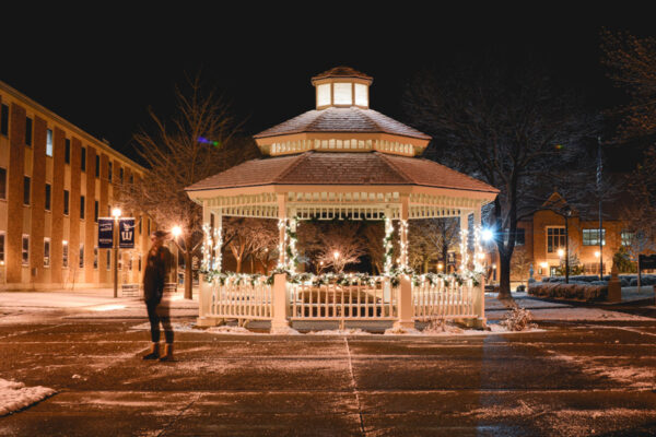 The gazebo is decorated with lights and garland in the winter.