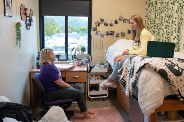 Two female students hang out in a residence hall room in Kirkland Hall in Winona.