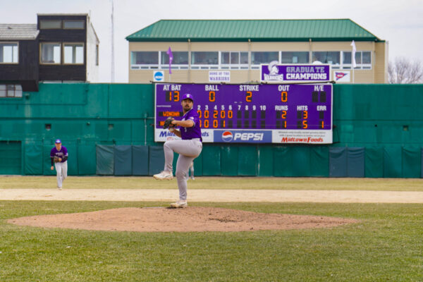 An athlete winds up for a pitch during a baseball game at the WSU baseball stadium.