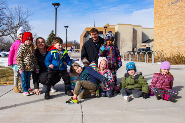 A group of children dressed in winter clothes outside the WSU Children's Center.