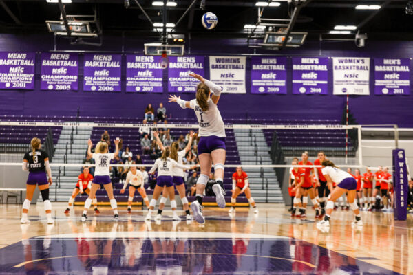An athlete spikes the ball during a volleyball game in the WSU McCowyn Gym.