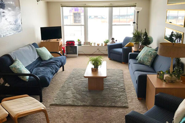 A living room in East Lake Apartments with furniture, a tv, and decor.