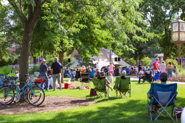 People sit in lawn chairs to attend an outdoor event on the WSU campus.