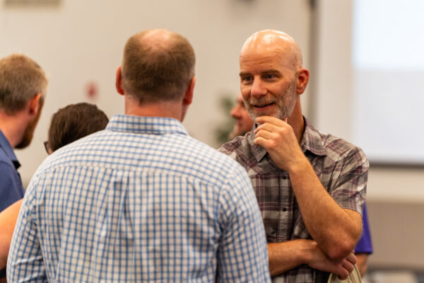 Faculty have a conversation at an event on the WSU campus.