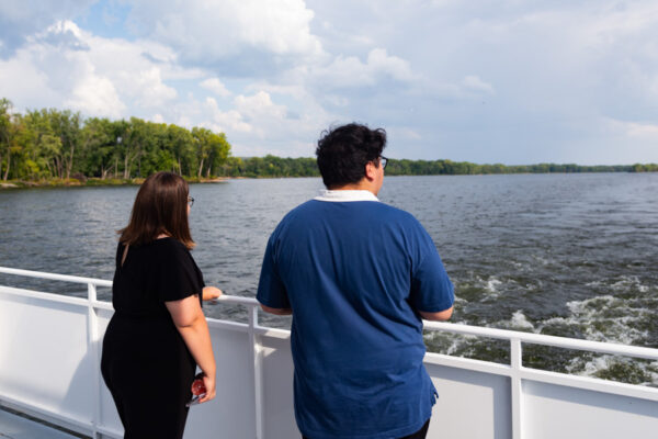 Two students look out on the Mississippi River from the Cal Fremling boat.