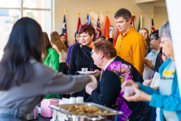Community members line up for a food at an event on the WSU campus in Winona.