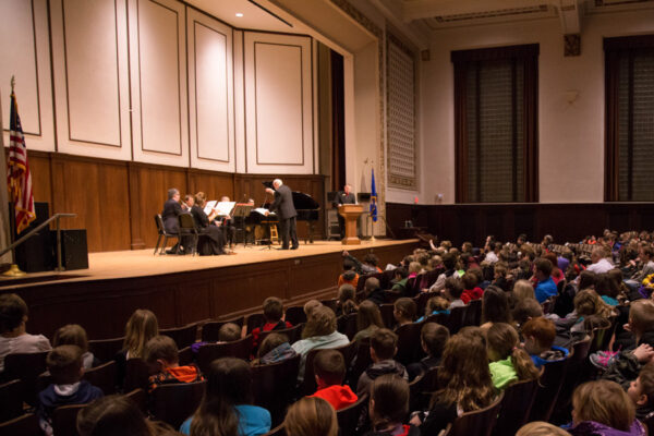 A small ensemble performs for a crowd in the Johnson Auditorium in Somsen Hall.