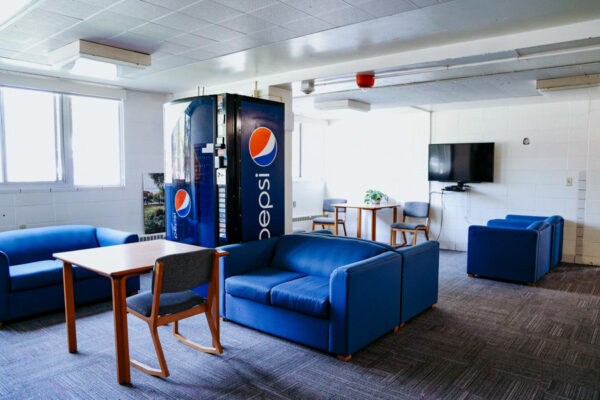 A lounge with several tables, chairs, and couches in Conway Hall.