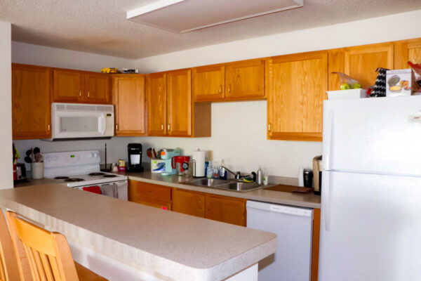 A kitchen with an island in East Lake Apartments.