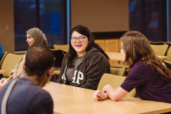 Students chat during a meeting in the Kirkland-Haake Hall conference room.