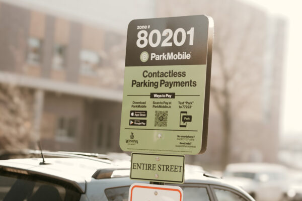 A sign on the street around WSU campus with instructions for using the parking meter app.