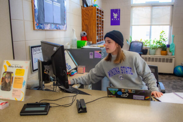 A student worker sits at the front desk in Richards Hall.