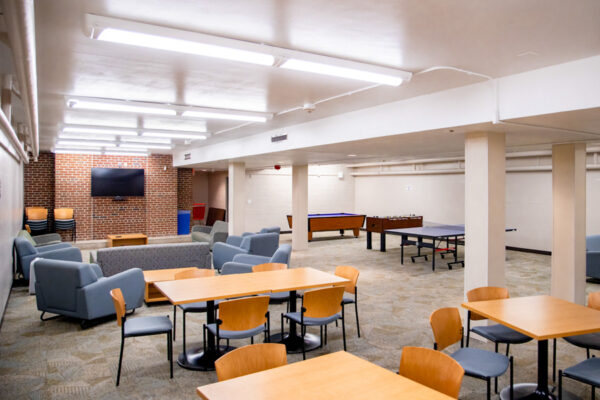 A lounge with many tables, chairs, and couches in Richards Hall.