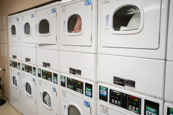 A wall of stacked washers and dryers in a laundry room in Sheehan Hall.