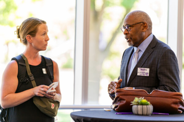 Two WSU staff have a conversation at a campus event.