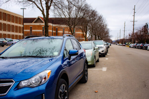 A row of cars parked on the street near the WSU Library in Winona.