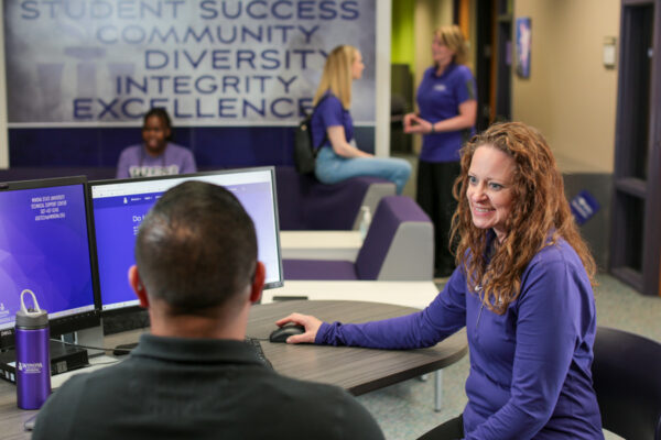 A student meets with an advisor in the WSU-Rochester Student & Campus Services Office.