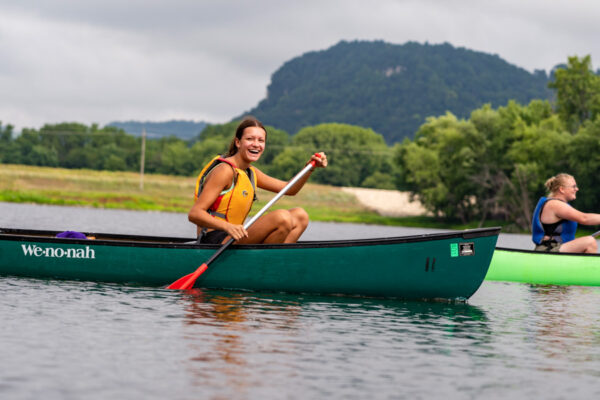 A student enjoys paddling a canoe on the Mississippi River backwaters.