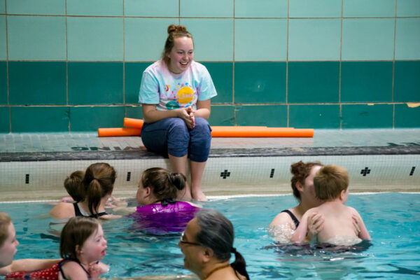 A student instructs a children's swimming lesson at the Memorial Hall Pool on the WSU campus.