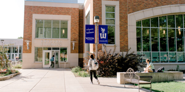 A student enters Kryzsko Commons from the interior courtyard on the Winona campus.