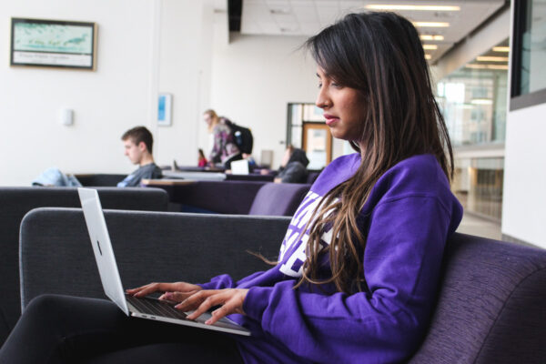 WSU student using a laptop in Baldwin Lounge.
